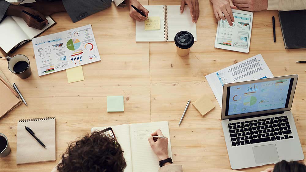 A team of people working on a Google Slide presentation